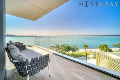 a balcony with a table and a view of the ocean at Bluewaters Residences 5, Bluewaters Island - Mint Stay in Dubai