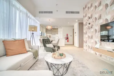 a living room with a couch and a table at Decent 1BR at Azizi Riviera 17, Al Merkadh by Deluxe Holiday Homes in Dubai