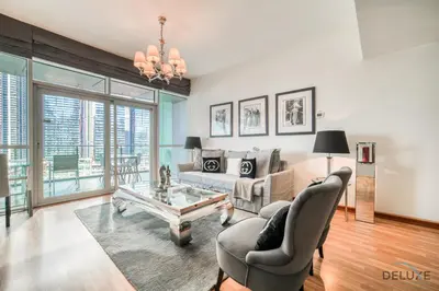 a living room with a couch and a table at Contemporary 1BR at Marina Terrace Tower Dubai Marina by Deluxe Holiday Homes in Dubai