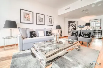 a living room with a couch and a table at Contemporary 1BR at Marina Terrace Tower Dubai Marina by Deluxe Holiday Homes in Dubai
