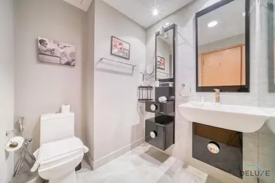 a bathroom with a sink and a toilet and a mirror at Contemporary 1BR at Marina Terrace Tower Dubai Marina by Deluxe Holiday Homes in Dubai
