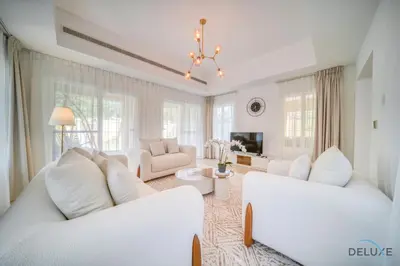 a living room with two white couches and a tv at Luxury 3BR Villa with Assistant Room at Alvorada 4 Arabian Ranches by Deluxe Holiday Homes in Dubai