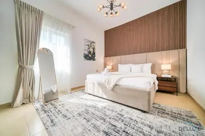 a bedroom with a large bed and a large window at Luxury 3BR Villa with Assistant Room at Alvorada 4 Arabian Ranches by Deluxe Holiday Homes in Dubai