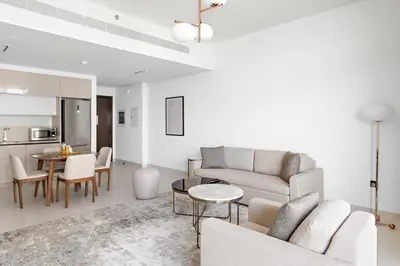 a living room with a couch and a table at Silkhaus Beach Vibes with Harbor View & Private Beach in Dubai