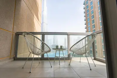 two chairs and a table on a balcony with a view at Luxury 2BR Superior Apartment with Full Burj Khalifa and Dubai Mall Dancing Fountain View, Royal Tiffany in Dubai