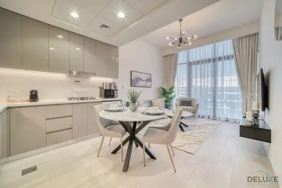 a kitchen and dining room with a table and chairs at Sizeable 1BR at Azizi Riviera 35, Al Merkadh by Deluxe Holiday Homes in Dubai