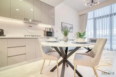 a kitchen and dining room with a table and chairs at Sizeable 1BR at Azizi Riviera 35, Al Merkadh by Deluxe Holiday Homes in Dubai