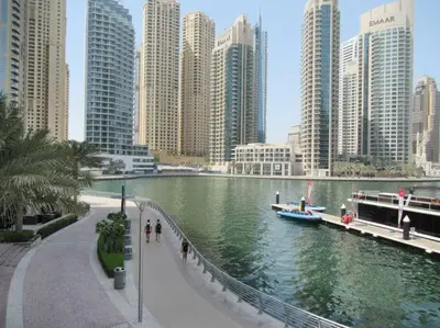 a river in a city with tall buildings at Frank Porter - Marina Views Tower B in Dubai