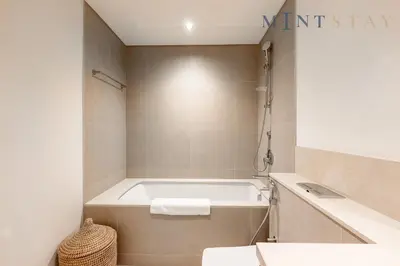 a bathroom with a bath tub and a sink at Burj Crown , Downtown Dubai - Mint Stay in Dubai