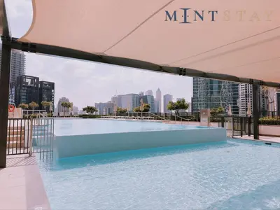 a swimming pool on the roof of a building with a view of the city at Burj Crown , Downtown Dubai - Mint Stay in Dubai