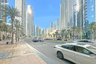 a city street with cars driving down a street with tall buildings at bnbmehomes - Forte in Dubai