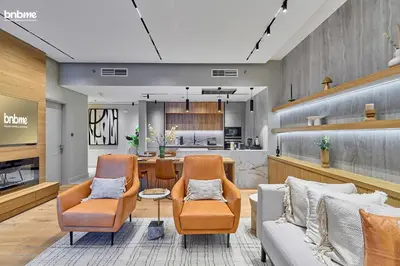 a living room with two chairs and a table at bnbmehomes - Forte in Dubai