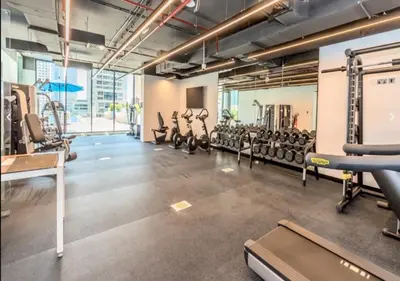 a gym with rows of treadmills and machines at LIV Residence - Luxurious 2BR - Dubai Marina View - Marina Walk in Dubai