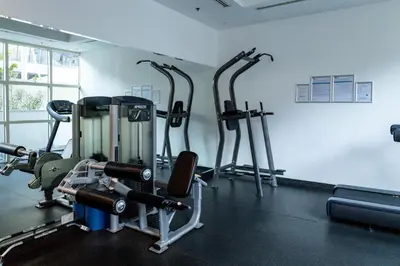a gym with several tread machines in a room at Trophy - Marina Urban Serenity Suite in Dubai