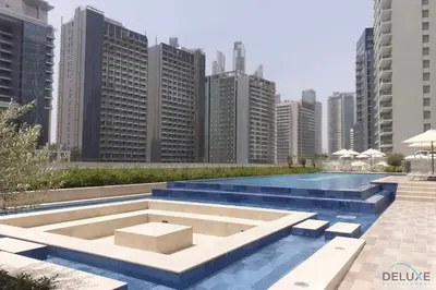 a pool in the middle of a city with tall buildings at Exclusive Deal, Chic 1BR at a Special Price by Deluxe Holiday Homes in Dubai