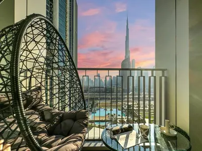 a balcony with a glass table and a view of a city at Amazing Burj Khalifa Views with Direct Dubai Mall Access, 2BR Apartment in Downtown Dubai in Dubai