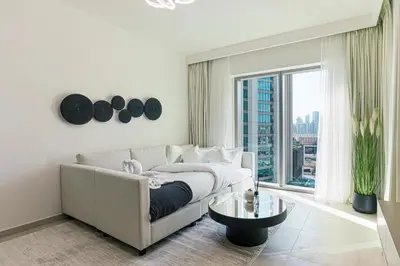 a living room with a white couch and a large window at Amazing Burj Khalifa Views with Direct Dubai Mall Access, 2BR Apartment in Downtown Dubai in Dubai