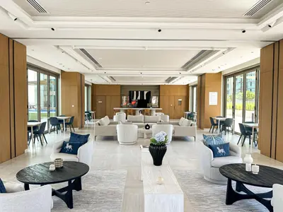 a lobby with tables and chairs and a living room at Amazing Burj Khalifa Views with Direct Dubai Mall Access, 2BR Apartment in Downtown Dubai in Dubai