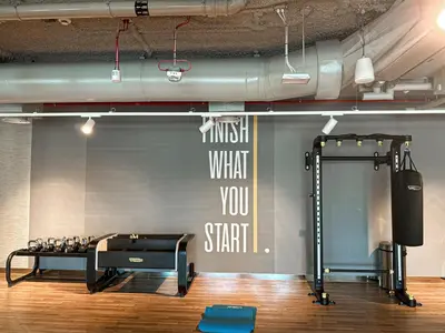 a gym with a treadmill and a wall with a screen at Amazing Burj Khalifa Views with Direct Dubai Mall Access, 2BR Apartment in Downtown Dubai in Dubai