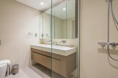 a bathroom with a sink and a shower at Marvelous Apartment in Beachfront Private Beach in Dubai