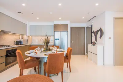 a kitchen and dining room with a table and chairs at Marvelous Apartment in Beachfront Private Beach in Dubai