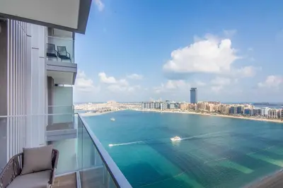 a view of the ocean from a balcony of a building at Marvelous Apartment in Beachfront Private Beach in Dubai