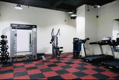 a gym with several treadmills and machines in a room at Full sea view with balcony - Studio Apartment - 10 min to JBR - in Dubai