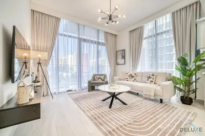 a living room with a couch and a table at Ravishing 2BR at Azizi Riviera 30, Al Merkadh by Deluxe Holiday Homes in Dubai
