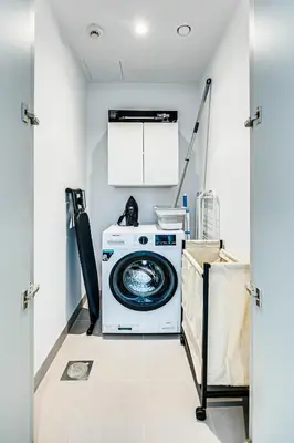 a washer and dryer in a laundry room at Pleasant 1BD apartment with the beach access in Dubai