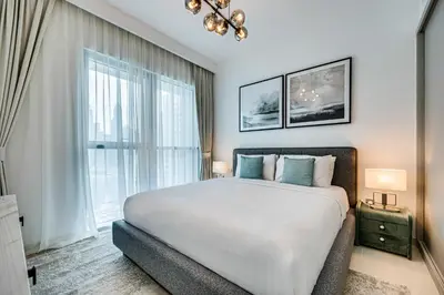 a bedroom with a large bed and a large window at Pleasant 1BD apartment with the beach access in Dubai