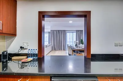 a kitchen with a view of a living room at Delightful 2BD apartment near the JBR in Dubai