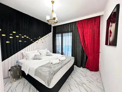a bedroom with a large bed with red curtains at Stay in heart of Dubai Marina walk to JBR beach 8 in Dubai