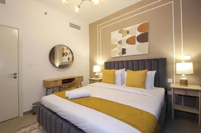 a bedroom with a large bed with yellow pillows at RH -Skyline Serenity, High-Floor Oasis in Downtown, walk to Burj Khalifa in Dubai