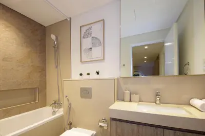 a bathroom with a sink and a tub and a toilet at RH -Skyline Serenity, High-Floor Oasis in Downtown, walk to Burj Khalifa in Dubai