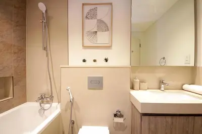 a bathroom with a sink and a toilet and a shower at RH -Skyline Serenity, High-Floor Oasis in Downtown, walk to Burj Khalifa in Dubai