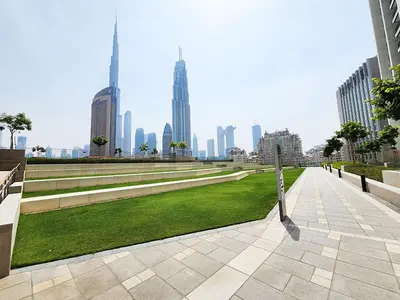 a park in the middle of a city with tall buildings at RH -Skyline Serenity, High-Floor Oasis in Downtown, walk to Burj Khalifa in Dubai