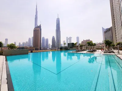 a large swimming pool in the middle of a city at RH -Skyline Serenity, High-Floor Oasis in Downtown, walk to Burj Khalifa in Dubai