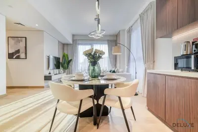 a kitchen and dining room with a table and chairs at Magnificent 2BR at La Voile Jumeirah by Deluxe Holiday Homes in Dubai