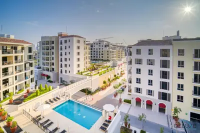an aerial view of a building with a swimming pool at Magnificent 2BR at La Voile Jumeirah by Deluxe Holiday Homes in Dubai