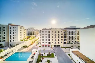 an overhead view of a building with a swimming pool at Magnificent 2BR at La Voile Jumeirah by Deluxe Holiday Homes in Dubai