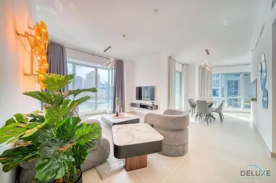 a living room with a couch and a chair at Elegant 2BR at Beauport XI Dubai Marina by Deluxe Holiday Homes in Dubai