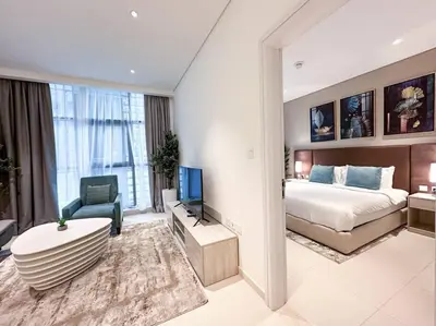 a hotel room with a bed and a tv at Seaside 1BR Getaway - Seven Palm in Dubai