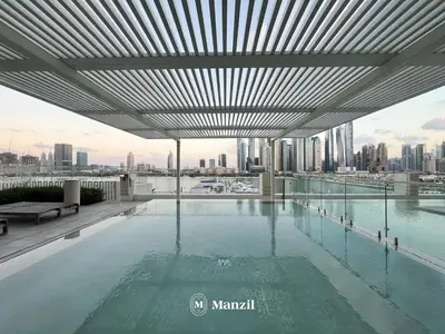 a swimming pool on the roof of a building at Manzil - 1BR Apartment in Emaar Beachfront with Private Beach & Marina Access in Dubai