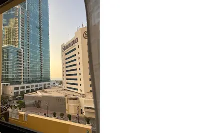 a view of a building from a window at FavDubai presents 2BR apartment in The Heart of JBR and Dubai Marina 150 m to JBR Beach with famous Ain Dubai view the biggest ferris wheel in the world Swimming pool access, air-conditioned gym, free parking & Housekeeping in Dubai