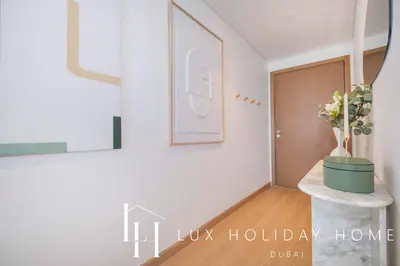 a living room with a potted plant on a table at LUX The Downtown Zabeel View Suite 2 in Dubai