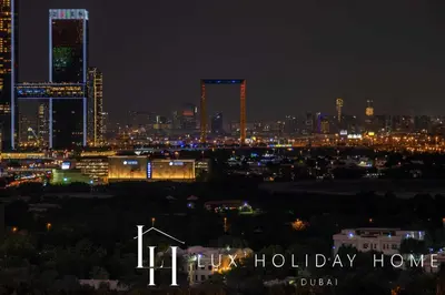 a city skyline at night with the words hilley holiday home at LUX The Downtown Zabeel View Suite 2 in Dubai