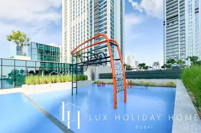 a playground in the middle of a pool with tall buildings at LUX The Downtown Zabeel View Suite 2 in Dubai