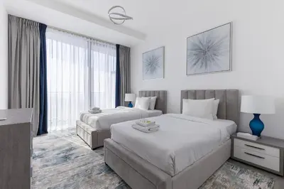 a bedroom with two beds and a large window at Stella Maris High Floor,Stunning Skyline Views in Dubai