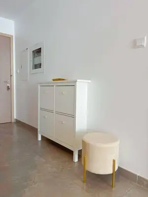 a white dresser and a stool in a room at Stella Maris High Floor,Stunning Skyline Views in Dubai