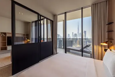 a bedroom with a large bed with a view of the city at UPSIDE LIVING Downtown Business & Leisure in Dubai